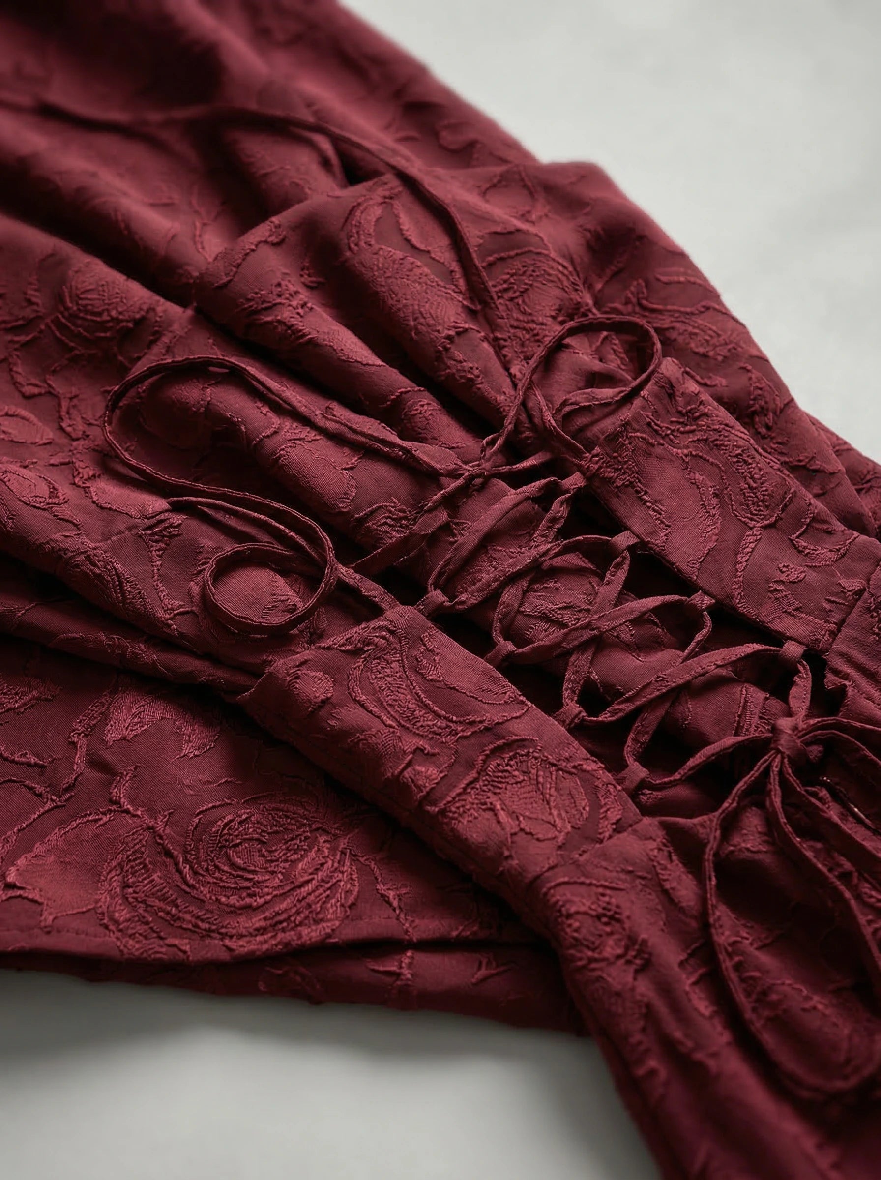 Elegant red occasion dress with textured jacquard fabric